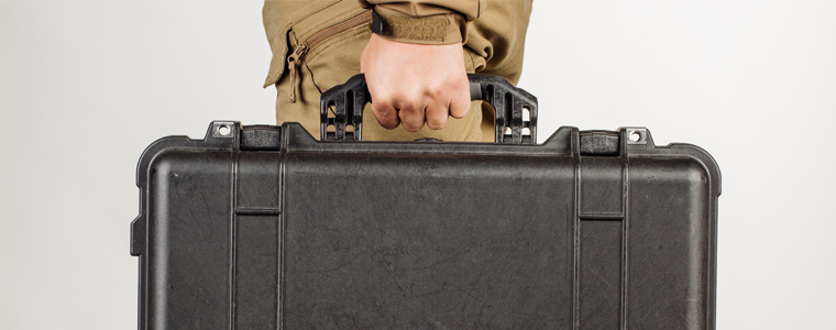 man carrying gun case