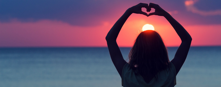 girl holding hands above head in heart