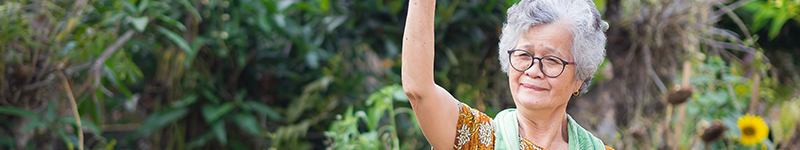 Respectable elder woman waving from the yard