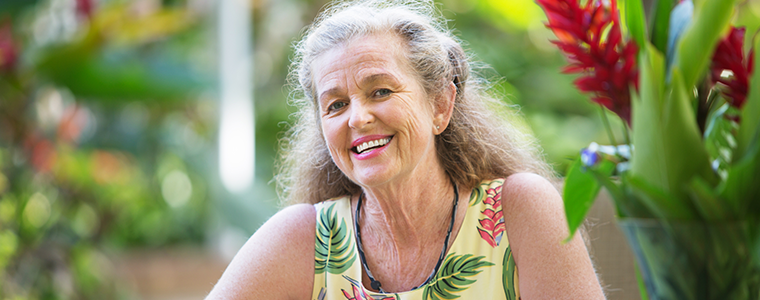 retired woman smiling in her garden